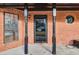 Close-up view of the front door featuring detailed brickwork and craftsman columns at 8914 Gardener Dr, Jonesboro, GA 30238