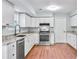Updated kitchen featuring white cabinetry, stainless steel appliances, and granite countertops at 8914 Gardener Dr, Jonesboro, GA 30238