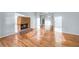 Open-concept living room boasts hardwood floors, a brick fireplace, and abundant natural light at 8914 Gardener Dr, Jonesboro, GA 30238