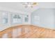 Spacious main bedroom with hardwood floors, ceiling fan, and large windows providing natural light at 8914 Gardener Dr, Jonesboro, GA 30238