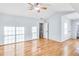 Bright main bedroom featuring hardwood floors, ceiling fan, and access to the en-suite bath at 8914 Gardener Dr, Jonesboro, GA 30238