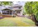 Spacious backyard with lush lawn, a screened porch, and a sports net, perfect for outdoor activities at 1043 Elizabeth Ne Ct, Atlanta, GA 30306