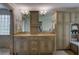 Elegant bathroom boasting double vanity, custom cabinetry and framed mirrors with sconce lighting at 1043 Elizabeth Ne Ct, Atlanta, GA 30306