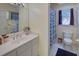 Bright bathroom with a vanity, mirror, toilet, and a shower with a blue patterned curtain at 1043 Elizabeth Ne Ct, Atlanta, GA 30306