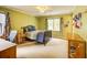 Yellow bedroom with a window, a ceiling fan, a wooden bed and some wooden furniture at 1043 Elizabeth Ne Ct, Atlanta, GA 30306