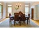 Formal dining room with elegant chandelier, hardwood floors, and patterned wallpaper at 1043 Elizabeth Ne Ct, Atlanta, GA 30306