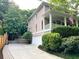 Charming home with a well-manicured lawn, an American flag, and a driveway leading to a garage at 1043 Elizabeth Ne Ct, Atlanta, GA 30306