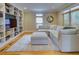 Cozy living room featuring built-in bookshelves, a large sectional, and natural light at 1043 Elizabeth Ne Ct, Atlanta, GA 30306