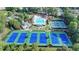 Aerial view of community pool and tennis courts, surrounded by mature trees at 2485 Millwater Xing, Dacula, GA 30019