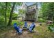 Private backyard oasis with a fire pit, seating area, and lush landscaping at 2485 Millwater Xing, Dacula, GA 30019