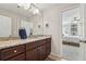 Bathroom featuring wood cabinets, granite countertops, with a view of the bedroom at 2485 Millwater Xing, Dacula, GA 30019