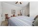 Bedroom featuring a serene color palette, ceiling fan and comfortable seating at 2485 Millwater Xing, Dacula, GA 30019