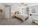Bright bedroom with a ceiling fan, built-in shelving, and neutral carpeting at 2485 Millwater Xing, Dacula, GA 30019