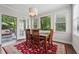 Dining area featuring hardwood floors, a door to the outside deck, and large windows with wooded views at 2485 Millwater Xing, Dacula, GA 30019