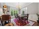 Dining area featuring large windows, classic furniture, a bright chandelier, and neutral wall colors at 2485 Millwater Xing, Dacula, GA 30019