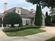 Beautiful home exterior with manicured lawn, mature trees, and charming architectural details at 2485 Millwater Xing, Dacula, GA 30019