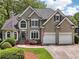 Beautiful two-story home with a manicured front yard, two-car garage, and a charming entrance at 2485 Millwater Xing, Dacula, GA 30019