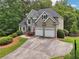 Stunning two-story home with lush landscaping, two-car garage, and inviting curb appeal at 2485 Millwater Xing, Dacula, GA 30019