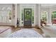 Spacious foyer with a front door view, hardwood floors, and detailed trim work at 2485 Millwater Xing, Dacula, GA 30019