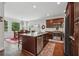 Kitchen featuring stainless steel appliances, a granite island, and hardwood floors, adjacent to the dining area at 2485 Millwater Xing, Dacula, GA 30019