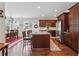 Kitchen with a granite island, stainless appliances, hardwood floors, and views of the breakfast area at 2485 Millwater Xing, Dacula, GA 30019