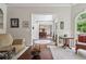 Cozy living room with a fireplace, large windows, and comfortable seating arrangement at 2485 Millwater Xing, Dacula, GA 30019
