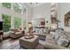 Spacious living room featuring a wall of windows, hardwood floors, and an open layout to the kitchen at 2485 Millwater Xing, Dacula, GA 30019