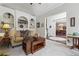 Inviting living room featuring built-in shelving and an open view to the dining area at 2485 Millwater Xing, Dacula, GA 30019