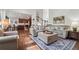 Open-concept living room featuring a large sectional sofa, fireplace, and an open view to the kitchen at 2485 Millwater Xing, Dacula, GA 30019