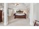 Spacious main bedroom with tray ceilings, stylish furniture, and lots of natural light at 2485 Millwater Xing, Dacula, GA 30019