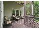 Relaxing back porch with comfortable seating and wooded views at 2485 Millwater Xing, Dacula, GA 30019