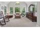 Relaxing sitting area featuring a rocking chair and windows with green views at 2485 Millwater Xing, Dacula, GA 30019