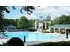 Large outdoor swimming pool with lounge chairs and umbrellas for relaxing by the water at 2485 Millwater Xing, Dacula, GA 30019