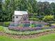 Charming water wheel surrounded by colorful flowers and lush greenery in a serene setting at 2485 Millwater Xing, Dacula, GA 30019
