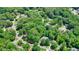 Aerial view shows the property surrounded by large, mature trees at 3267 Standing Peachtree Nw Trl, Kennesaw, GA 30152