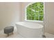This soaking tub is located underneath a bright window that lets in lots of natural light at 3267 Standing Peachtree Nw Trl, Kennesaw, GA 30152