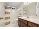 This bathroom features white tile and a shower-tub combo at 3267 Standing Peachtree Nw Trl, Kennesaw, GA 30152