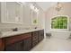 Dual sinks and a freestanding tub are highlights of this bright, tiled bathroom at 3267 Standing Peachtree Nw Trl, Kennesaw, GA 30152