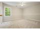 Bright bedroom featuring neutral carpet, a ceiling fan, and a window with a view at 3267 Standing Peachtree Nw Trl, Kennesaw, GA 30152