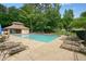 Community pool with lounge chairs and umbrellas offers a relaxing outdoor experience at 3267 Standing Peachtree Nw Trl, Kennesaw, GA 30152