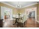 Bright dining room showcasing hardwood floors, chandelier, and neutral paint at 3267 Standing Peachtree Nw Trl, Kennesaw, GA 30152