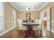 Formal dining room featuring natural light, hardwood floors, and elegant chandelier at 3267 Standing Peachtree Nw Trl, Kennesaw, GA 30152
