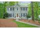 Charming two-story home with a brick facade, symmetrical windows, and landscaped front yard at 3267 Standing Peachtree Nw Trl, Kennesaw, GA 30152
