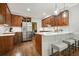 Modern kitchen featuring wood cabinets, stainless steel appliances, and breakfast bar at 3267 Standing Peachtree Nw Trl, Kennesaw, GA 30152