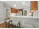 Stylish kitchen featuring white countertops, wood cabinets and seating at the island at 3267 Standing Peachtree Nw Trl, Kennesaw, GA 30152