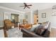 Open living room with fireplace, hardwood floors, classic furniture and views to the kitchen and office at 3267 Standing Peachtree Nw Trl, Kennesaw, GA 30152