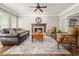 Cozy living room with a fireplace, hardwood floors, and an abundance of natural light at 3267 Standing Peachtree Nw Trl, Kennesaw, GA 30152