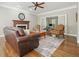 Warm living room featuring a fireplace, hardwood floors, and refined traditional furnishings at 3267 Standing Peachtree Nw Trl, Kennesaw, GA 30152