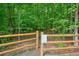Entrance to Butler Creek Nature Area with wooden gate and signage at 3267 Standing Peachtree Nw Trl, Kennesaw, GA 30152