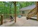 Back patio with forest views features outdoor seating and stairway at 3267 Standing Peachtree Nw Trl, Kennesaw, GA 30152